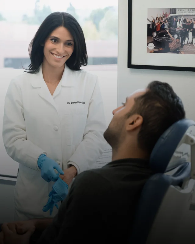 Dr. Danesh putting on her gloves before conducting an exam
