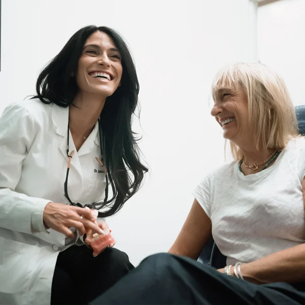 Dr. Davita Danesh and a laughing patient in an exam room
