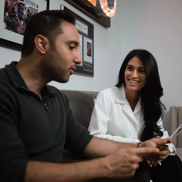 Dr. Danesh and a patient reviewing paperwork