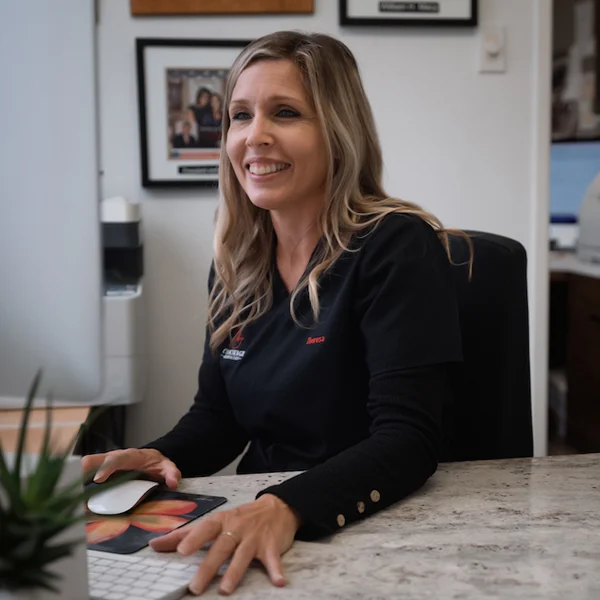 A receptionist at the front desk of the clinic